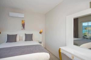 Postel nebo postele na pokoji v ubytování Mia Casa Hotel