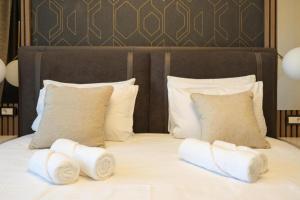 a bed with towels on top of it at Mountain Paradise Ski In & Out - Vila Golija Kopaonik in Kopaonik