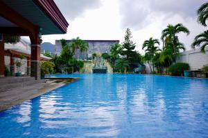 a large swimming pool with blue water in front of a building at Punta Verde Resort & Convention Center in Pansol +31 photos