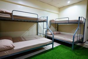 two bunk beds in a room with green grass at Punta Verde Resort & Convention Center in Pansol