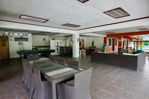 a dining room with a ping pong table and chairs at Punta Verde Resort & Convention Center in Pansol