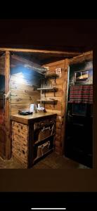 a kitchen in a log cabin with a counter at Brvnare Dolic in Sarajevo
