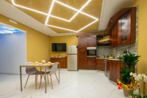 a kitchen with a table and a refrigerator at Morcone B&B Affittacamere in Morcone