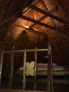 a room with a bed in a wooden attic at Brvnare Dolic in Sarajevo