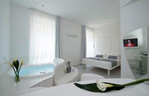 a white room with a bed and a sink at Gatto Bianco Mia Aparthotel in Milan +51 photos