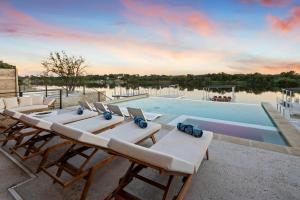a pool with chairs and a table and a swimming pool at The Enclave New Listing Concierge Services in Kingsland