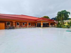 a building with a large pool of water in front of it at Punta Verde Resort & Convention Center in Pansol