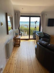 a living room with a couch and a view of the ocean at Sea Breeze in Poole