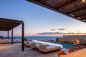 an outdoor living room with a view of the ocean at Jamyti Villa in Sellía