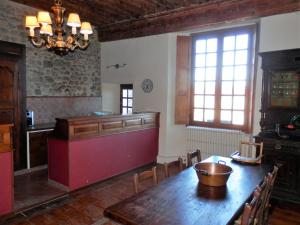 a kitchen with a large wooden table and a counter at Studio indépendant contre la Cathedrale - ancien couvent - 4eme etage sans ascenseur in Le Puy-en-Velay