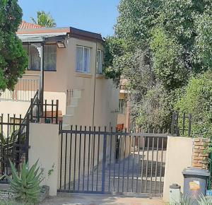 a gate in front of a house at Villa at Wekker in Pretoria