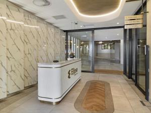 a lobby with a reception desk in a building at Ellipse Kepler High-Rise 2-Bedroom en-suite Luxury Apartment in Midrand +22 photos