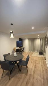 a large living room with a table and chairs at Maison cozy proche centre ville in Orvault