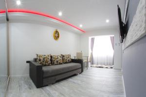 a living room with a couch and a window at Smart Apartament in Brăila
