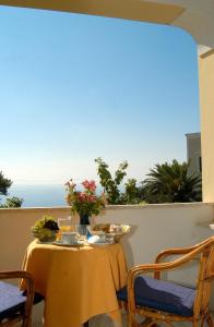 a table with chairs and a table cloth at Hotel Villa Sarah in Capri