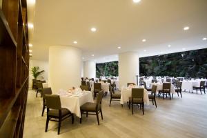 a banquet hall with white tables and chairs at Clarion Suites Guatemala City in Guatemala