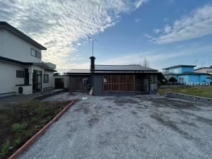 a house with a gravel driveway in front of it at JaM in Noboribetsu