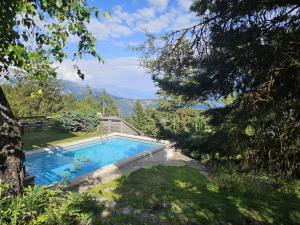 a swimming pool in the yard of a house at Vue 180 - Au pied des pistes - Typique et alpin in Anzère