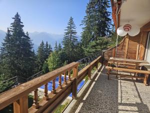 a balcony of a house with a view of the mountains at Vue 180 - Au pied des pistes - Typique et alpin in Anzère