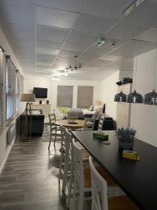 a kitchen and living room with a table and chairs at Modern Studio Flat in Bramhall in Bramhall