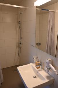 a bathroom with a sink and a shower at Landguet Ried - Center for mindful living in Bümpliz