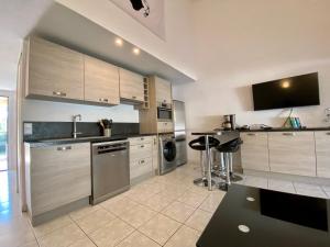 a large kitchen with stainless steel appliances and cabinets at Liflosa in Lecci +10 photos