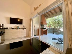 a kitchen with a large sliding glass door to a patio at Liflosa in Lecci