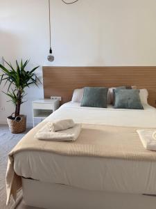 a bedroom with a large bed with two towels on it at Loft Mar Ruzafa-Parque central in Valencia