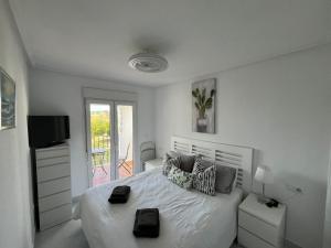 Biała sypialnia z łóżkiem i balkonem w obiekcie Luxury 2 bed Penthouse on Golf Course Murcia w mieście Sucina +37 zdjęć