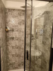 a shower with a glass door in a bathroom at Bilocale Funivie in Breuil-Cervinia