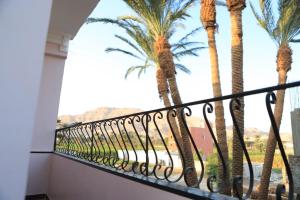 een balkon met uitzicht op palmbomen bij Habiba Apartment in Luxor