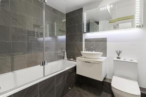 a white bathroom with a sink and a toilet at Manor House Apartment - Indoor Heated Pool, Parking in Torquay