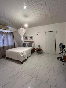 a bedroom with a bed and a table in it at Kasuba Two Bedroom Apartment in Livingstone