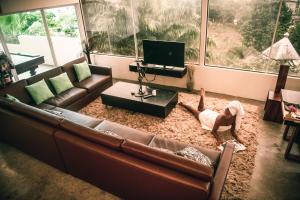 a woman laying on the floor in a living room at ME Hotel & Villas - Montañita Estates in Montañita