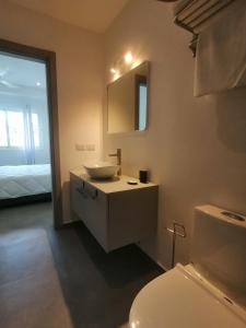 a bathroom with a white sink and a toilet at Sabrina Plaza Residence in Las Terrenas