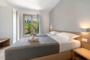 Ένα ή περισσότερα κρεβάτια σε δωμάτιο στο Residence Eleonora +41 φωτογραφίες