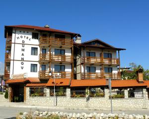 a large building with a sign on the side of it at Hotel Dumanov in Bansko