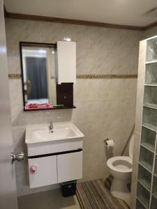 a bathroom with a sink and a toilet at 3BR Davao Condo 7thfloor near Airport in Pagamikan +23 photos
