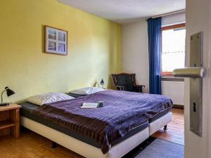 a bedroom with a bed with a purple comforter at Haus am Kreuzberg in Medebach