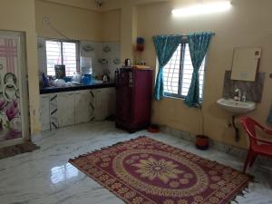 a room with a red refrigerator and a sink at Shiv sakti homestay in kolkata