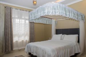 Postel nebo postele na pokoji v ubytování CRYSTAL HOMES By CHEMA