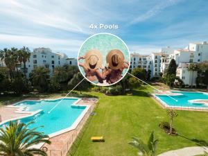 zdjęcie dwóch osób w kółko przy basenie w obiekcie VACATION MARBELLA I Brand New Terrazas de Banús Apt, 24-7 Security, a minute from the Marina, The Sea and Luxury Shopping w Marbelli