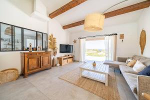 a living room with a couch and a tv at Maison accueillante à Roquebrune-sur-Argens avec piscine privée in Roquebrune-sur-Argens
