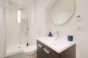 a bathroom with a sink and a toilet and a mirror at Le Cocon de Jeanne - Nancy Thermal - 2 Pers in Nancy +25 photos