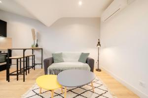 a living room with a couch and a table at Le Cocon de Jeanne - Nancy Thermal - 2 Pers in Nancy