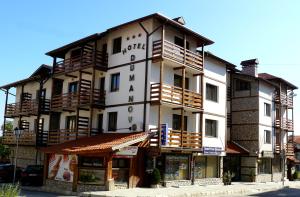 a large white building with balconies on it at Hotel Dumanov in Bansko