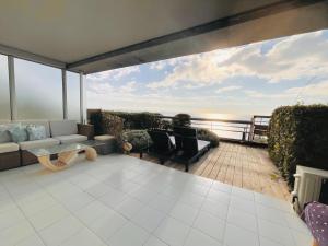 a living room with a view of the ocean at SARA RIVIERA Costa Plana in Cap d'Ail