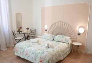 a bedroom with a large bed and tables and chairs at A casa di Mario e Nenè in Viareggio