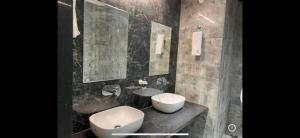 a bathroom with a toilet and a sink and mirror at Dhruvtara Farms in Jabalpur
