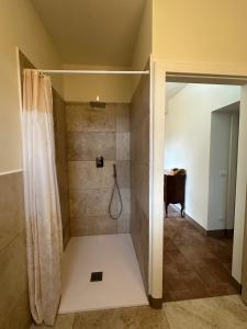 a bathroom with a shower with a shower curtain at Da Taz Siena in Siena